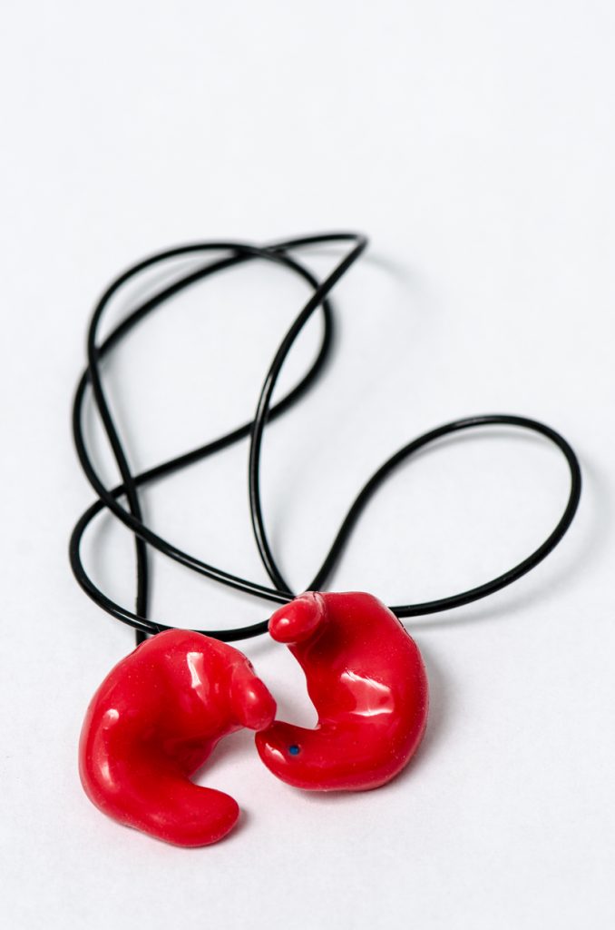Set of molded red ear plugs with a cord